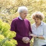 mid stage dementia_carer walking with patient outside