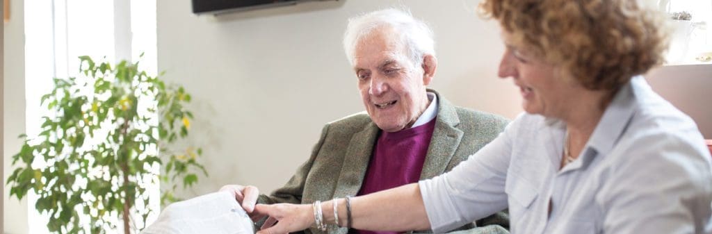 multiple sclerosis_carer reading newspaper with patient