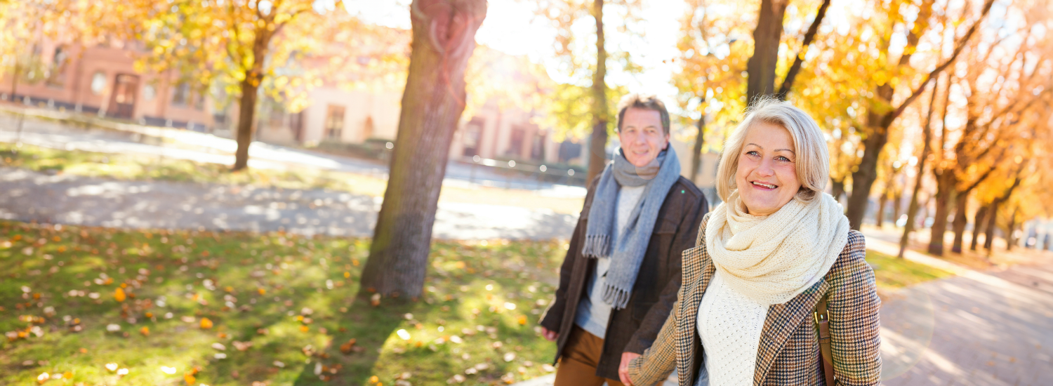 couple holding hands in autumnal park